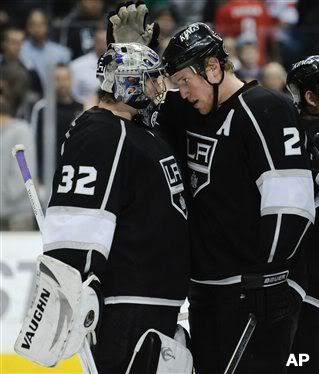 From left, Los Angeles Kings goalie Jonathan Quick (32), defenseman Matt Greene (2) celebrate their win over the Washington Capitals at the end of the third period of a NHL hockey game, Saturday, Jan. 2, 2010, in Los Angeles. The Kings won 2-1. (AP Photo/Gus Ruelas)