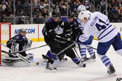 Toronto Maple Leafs right wing Nikolai Kulemin (41), of Russia, gets the puck by Los Angeles Kings center Anze Kopitar, center, of Slovenia, and Kings goalie Jonathan Quick (32) for a goal during the third period of an NHL hockey game, Monday, Jan. 10, 2011, in Los Angeles. The Maple Leafs won 3-2. (AP Photo/Gus Ruelas)