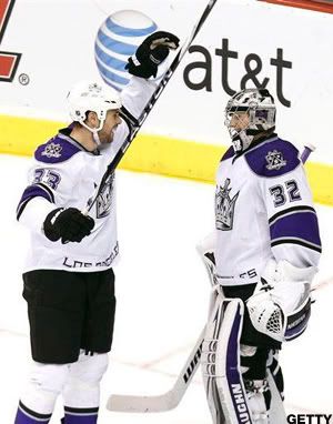 Los Angeles Kings' Jonathan Quick (32) celebrates a win over the Phoenix Coyotes with teammate Willie Mitchell (33) at the end of the third period in an NHL hockey game Saturday, Jan. 22, 2011, in Glendale, Ariz. The Kings defeated the Coyotes 4-3. (AP Photo/Ross D. Franklin)