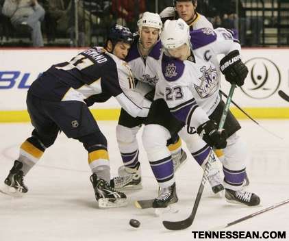 SANFORD MYERS / THE TENNESSEAN Predators center David Legwand (11) ties up Kings left wing Ryan Smyth (94) as right wing Dustin Brown (23) spins away with the puck during the second period at Bridgestone Arena.