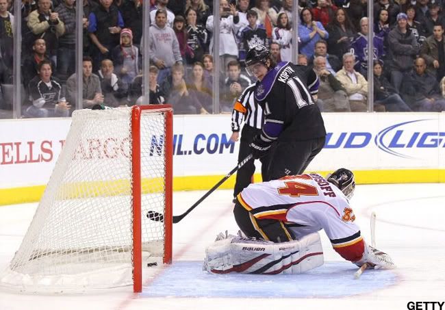 Anze Kopitar #11 of the Los Angeles Kings slips the puck between the pads of goaltender Miikka Kiprusoff #34 of the Calgary Flames for a goal during shootout overtime in their NHL game at Staples Center on March 21, 2011 in Los Angeles, California. The Kings defeated the Flames 2-1 in shootout overtime. (Photo by Victor Decolongon/Getty Images)