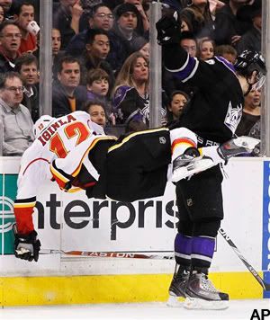 Los Angeles Kings' Drew Doughty, right, checks Calgary Flames' Jarome Iginla, left, during the second period of an NHL hockey game in Los Angeles on Monday, March 21, 2011. (AP Photo/Danny Moloshok)