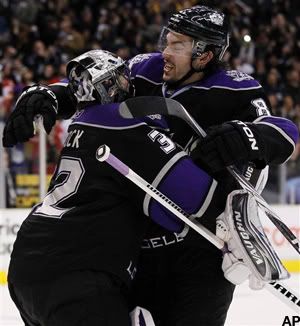 Los Angeles Kings goaltender Jonathan Quick, left, and defenseman Drew Doughty, right, celebrate the Kings' win after a shootout against Calgary Flames in an NHL hockey game in Los Angeles on Monday, March 21, 2011. The Kings won 2-1. (AP Photo/Danny Moloshok)
