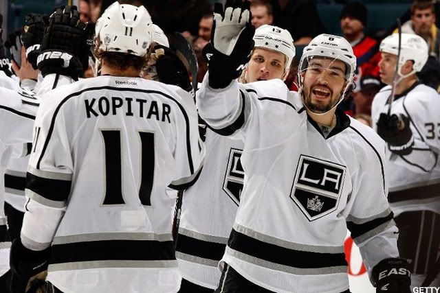 Anze Kopitar #11, Drew Doughty #8 and teammates of the Los Angeles Kings celebrate a 3-0 victory over the Calgary Flames on March 28, 2012 at the Scotiabank Saddledome in Calgary, Alberta, Canada. (Photo by Gerry Thomas/NHLI via Getty Images)