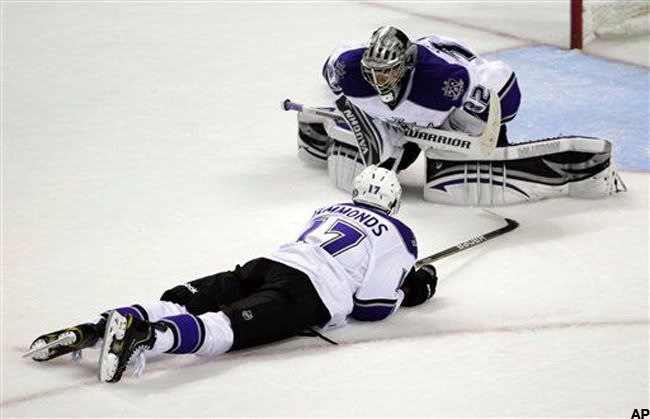 Los Angeles Kings goalie Jonathan Quick (32) and right wing Wayne Simmonds (17) lies on the ice after San Jose Sharks center Joe Pavelski, not shown, scored the winning goal during overtime in Game 1 to win 3-2- of an NHL hockey first-round Western Conference playoff series in San Jose, Calif., Thursday, April 14, 2011. (AP Photo/Paul Sakuma)
