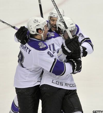 Anze Kopitar #11 of the Los Angeles Kings is congratulated by teammates Drew Doughty and Jack Johnson after scoring the game winning goal against the Vancouver Canucks during the overtime period in Game Two of the Western Conference Quarterfinals during the 2010 NHL Stanley Cup Playoffs on April 17, 2010 at General Motors Place in Vancouver, British Columbia, Canada. (Photo by Rich Lam/Getty Images)