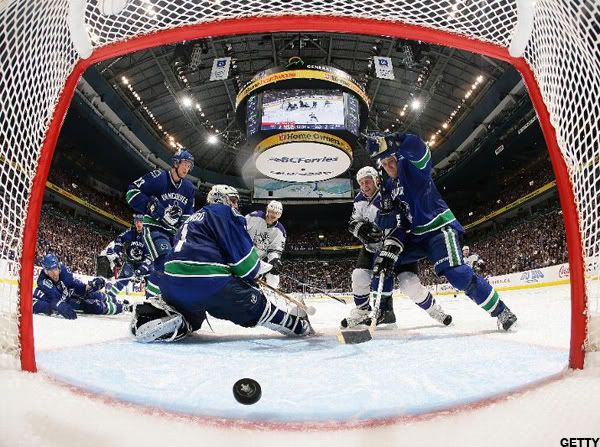 The shot of Anze Kopitar #11 of the Los Angeles Kings gets by Roberto Luongo #1 of the Vancouver Canucks for the overtime winning goal as Sami Salo #6 and Alexander Edler #23 of the Vancouver Canucks and Ryan Smyth #94 and Michal Handzus #26 of the Los Angeles Kings look in Game Two of the Western Conference Quarterfinals during the 2010 Stanley Cup Playoffs at General Motors Place on April 17, 2010 in Vancouver, British Columbia, Canada. Los Angeles won 3-2. Photo by Jeff Vinnick/NHLI via Getty Images)