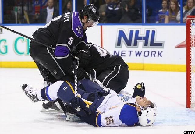 Drew Doughty #8 of the Los Angeles Kings pushes Jamie Langenbrunner #15 of the St. Louis Blues to the ice at the Scottrade Center on November 22, 2011 in St. Louis, Missouri. (Photo by Dilip Vishwanat/Getty Images)