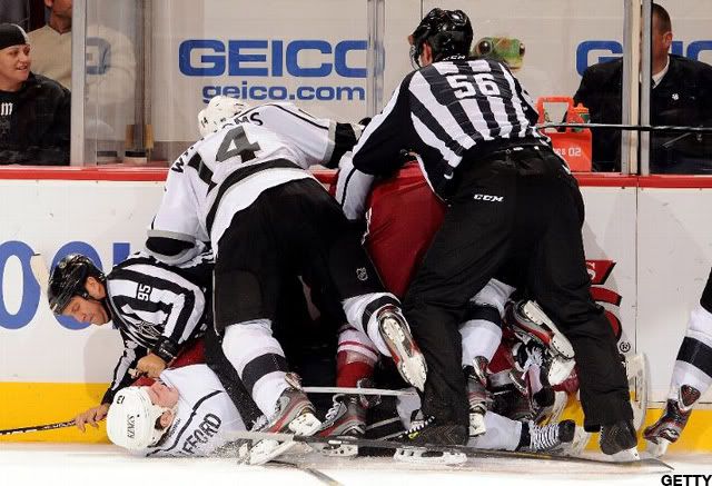 Linesman Jonny Murray #95 gets taken down with Kyle Clifford #13 of the Los Angeles Kings during scrum with the Phoenix Coyotes at Jobing.com Arena on February 21, 2012 in Glendale, Arizona. (Photo by Norm Hall/NHLI via Getty Images)