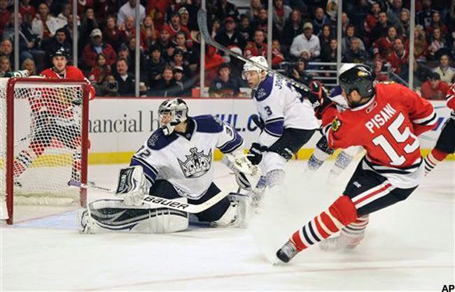 Los Angeles Kings goalie Jonathan Quick watches the puck go into the net on a goal by Chicago Blackhawks' Fernando Pisani (15) during the second period of an NHL hockey game Sunday, Dec. 19, 2010, in Chicago. (AP Photo/Jim Prisching)