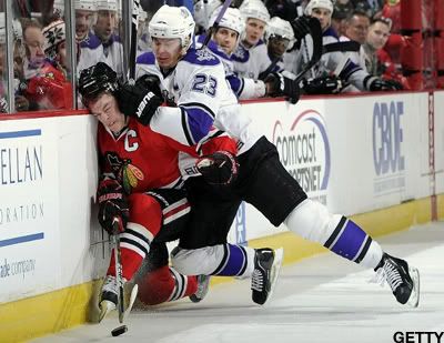 CHICAGO - DECEMBER 19: Dustin Brown #23 of the Los Angeles Kings slams Jonathan Toews #19 of the Chicago Blackhawks into the boards on December 19, 2010 at the United Center in Chicago, Illinois. (Photo by Bill Smith/NHLI via Getty Images)
