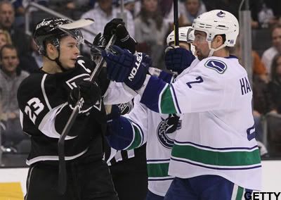 Dustin Brown #23 of the Los Angeles Kings and Dan Hamhuis #2 of the Vancouver Canucks get their sticks crossed after the play in the first period during the NHL game at Staples Center on December 31, 2011 in Los Angeles, California. (Photo by Victor Decolongon/Getty Images)